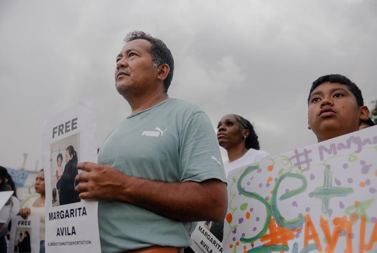 José and his son, Isaac attend a FIEL action in front of the Core Civic Processing Center where Margarita Avila and others are being detained, Friday, June 13, 2025, in Houston. The action focused on the increase in detentions, and let those inside the facility feel that they were not alone. (Lexi Parra for The Texas Tribune)